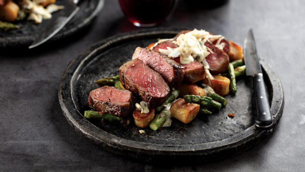 Cooked chateaubriand filet mignon roast with 5 medium-rare sliced pieces. Served with side cranberry sauce.